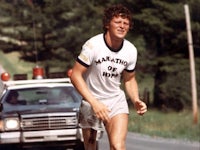 a man is running on a wet street