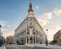 an ornate building with a clock tower in the middle of a city